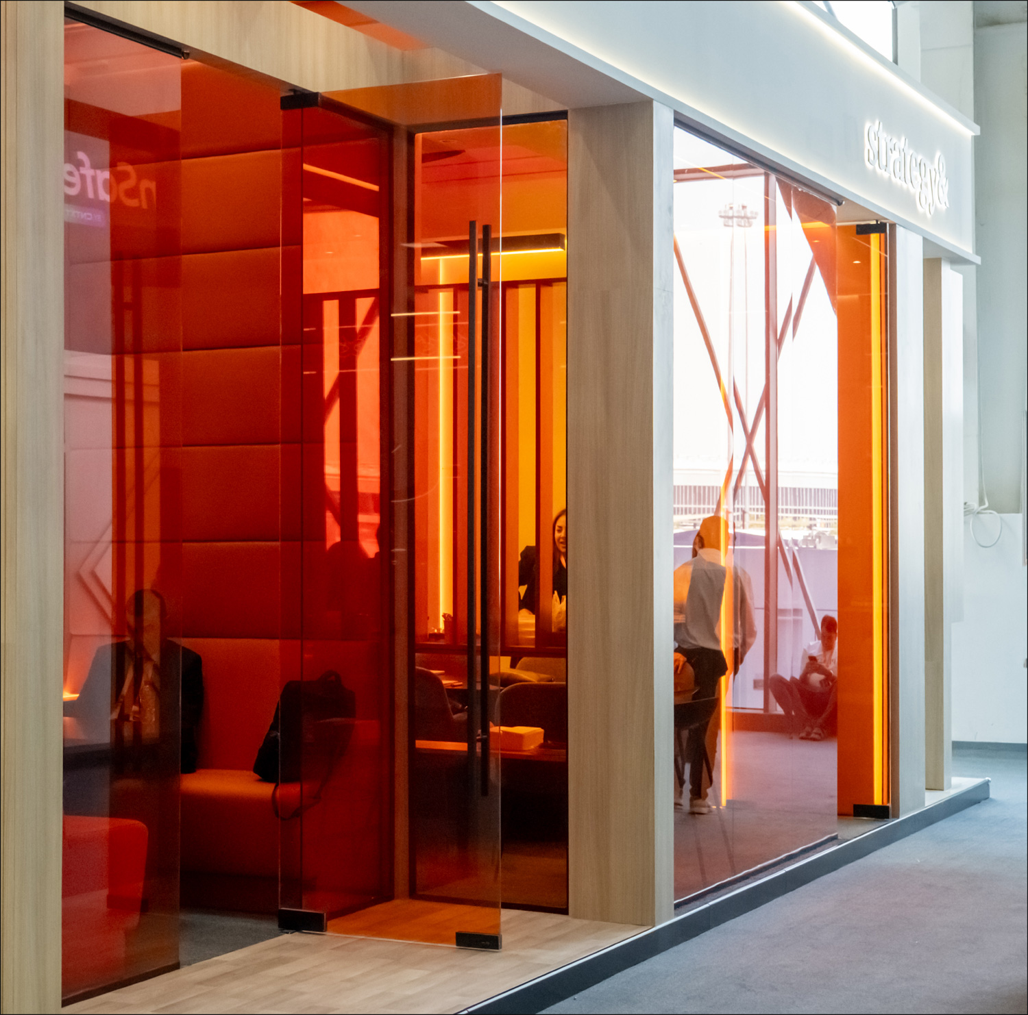 Orange-glazed private meeting room at PwC LEAP 2026