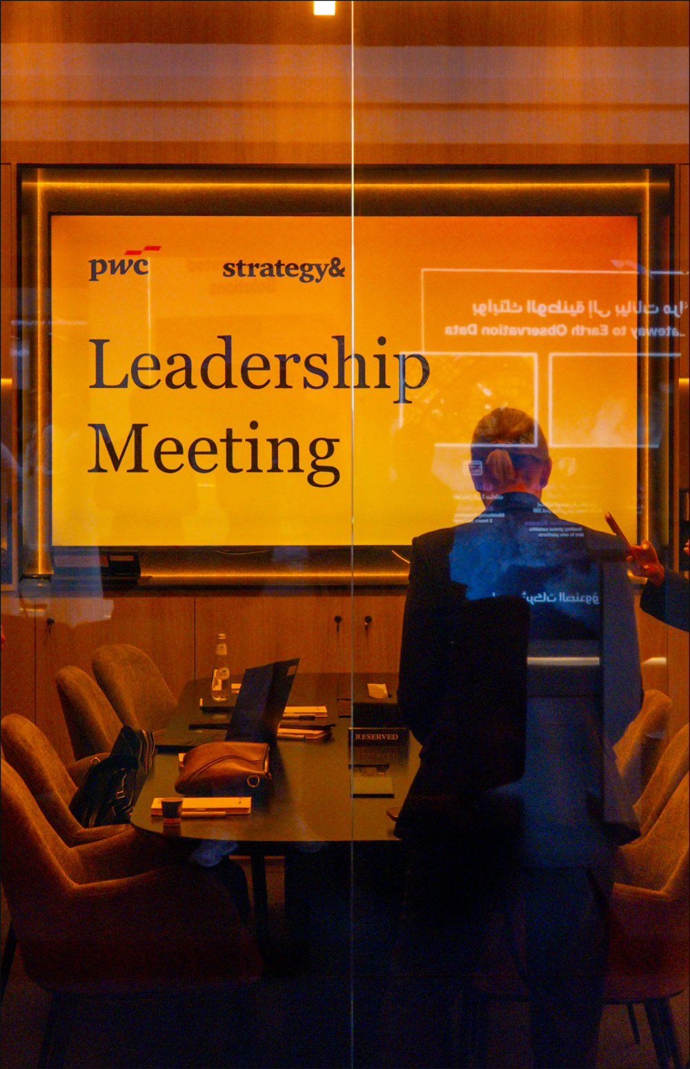 Leadership meeting viewed through orange glazing