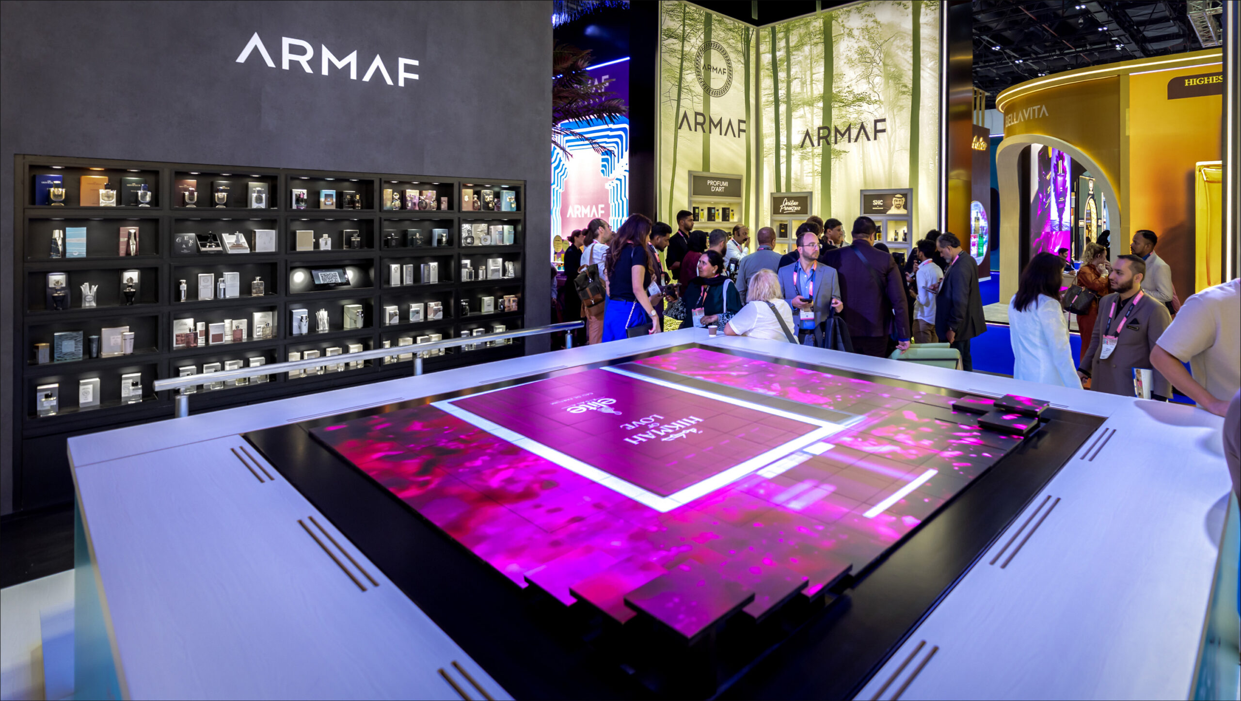 Visitors at the illuminated ARMAF fragrance table
